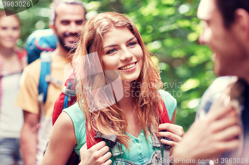 Image of group of smiling friends with backpacks hiking