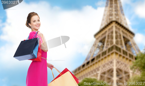 Image of woman with shopping bags over paris eiffel tower
