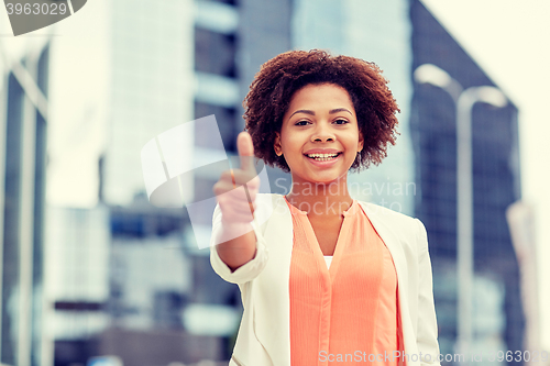 Image of happy young african american businesswoman in city