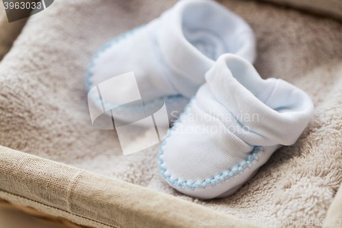 Image of close up of baby bootees for newborn boy in basket