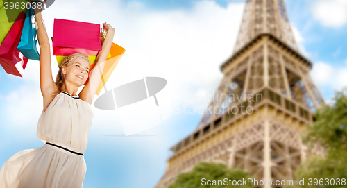 Image of woman with shopping bags over paris eiffel tower