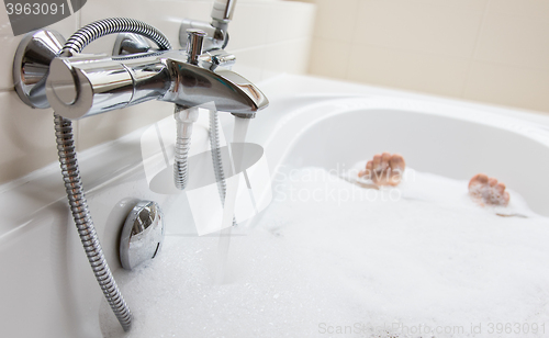 Image of Men\'s feet in a bathtub, selective focus