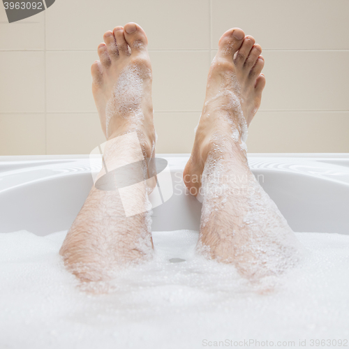 Image of Men\'s feet in a bathtub, selective focus on toes