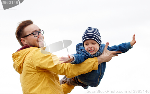 Image of father with son playing and having fun outdoors