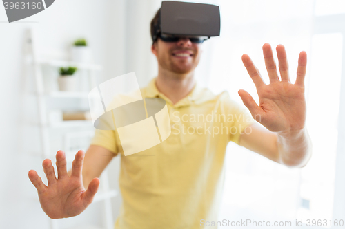 Image of young man in virtual reality headset or 3d glasses