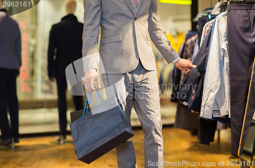 Image of close up of man with shopping bags at store