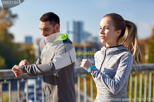 Image of couple running over city highway bridge