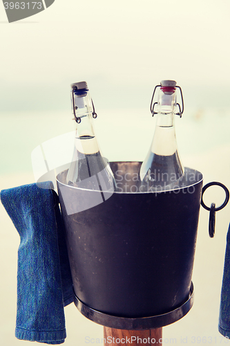 Image of water bottles in ice bucket at hotel beach