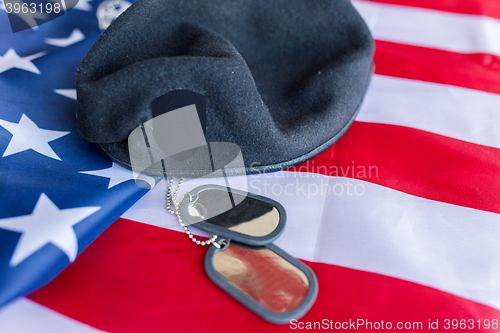 Image of close up of american flag, hat and military badge