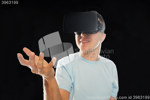 Image of happy man in virtual reality headset or 3d glasses