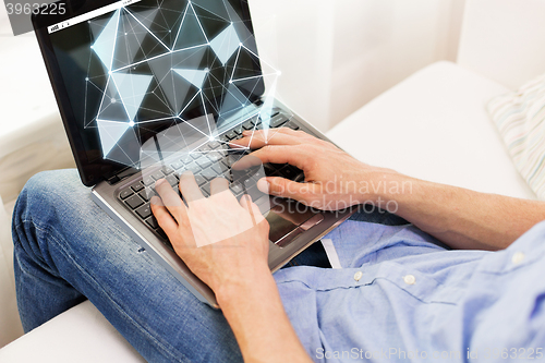 Image of close up of man typing on laptop computer at home