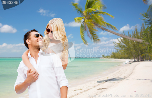 Image of happy couple in sunglasses over summer beach
