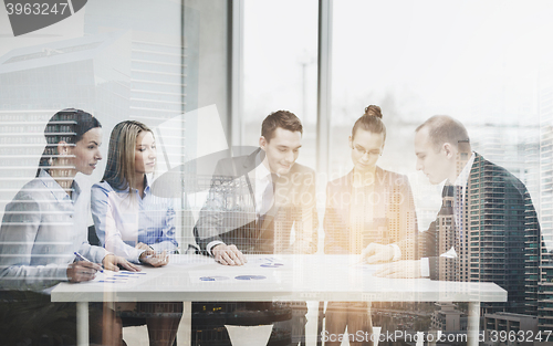 Image of business team with documents having discussion