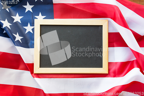 Image of close up of school blackboard on american flag