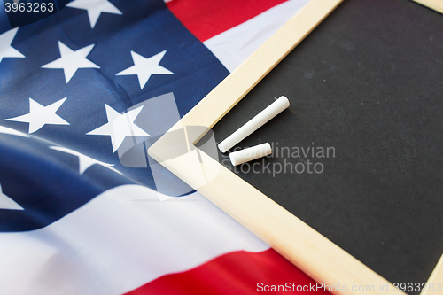 Image of close up of school blackboard on american flag