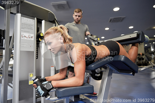 Image of man and woman flexing muscles on gym machine