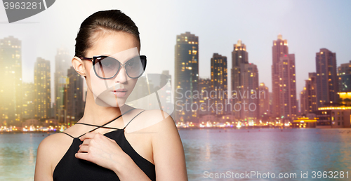 Image of beautiful young woman in elegant black sunglasses