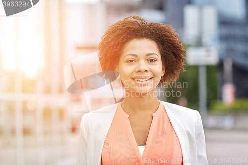Image of happy young african american businesswoman in city