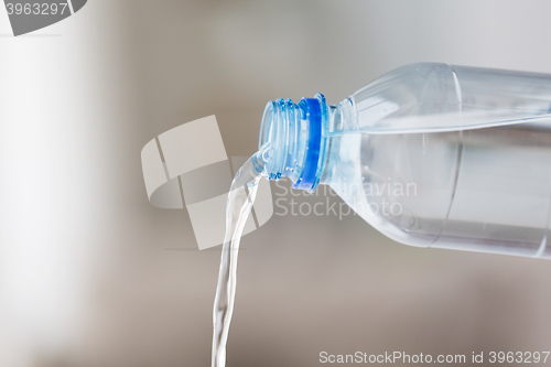 Image of close up of water pouring from plastic bottle