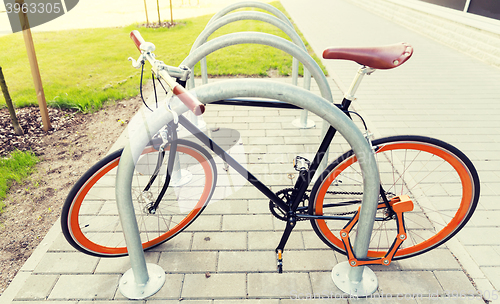 Image of close up of bicycle locked at street parking