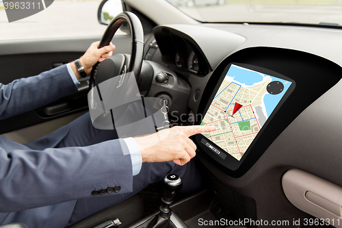 Image of close up of man driving car with gps navigator map