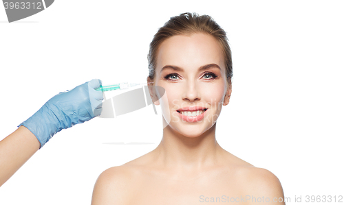 Image of woman face and hand with syringe making injection