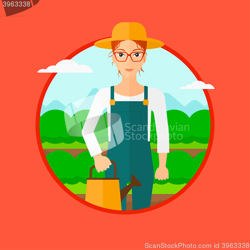 Image of Farmer with watering can at cabbage field.