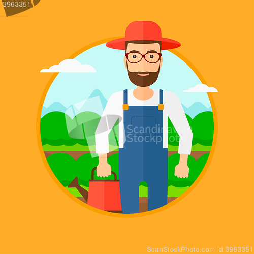 Image of Farmer with watering can at cabbage field.