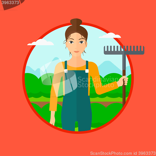 Image of Farmer with rake at cabbage field.