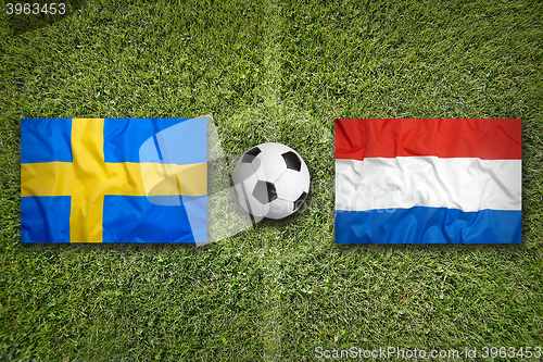 Image of Sweden vs. Netherlands flags on soccer field