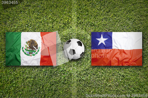 Image of Mexico vs. Chile flags on soccer field