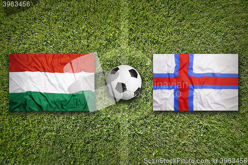 Image of Hungary vs. Faeroe Islands flags on soccer field
