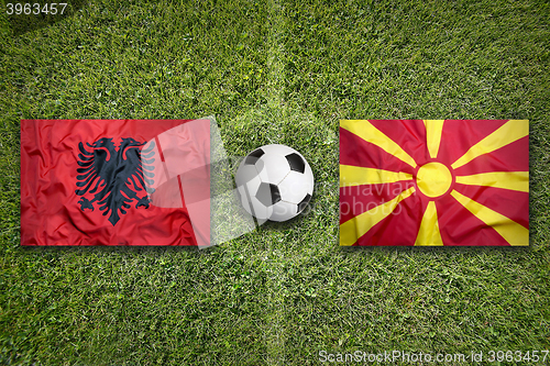 Image of Albania vs. Macedonia flags on soccer field