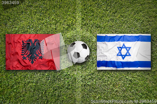 Image of Albania vs. Israel flags on soccer field