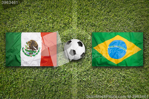 Image of Mexico vs. Brazil flags on soccer field