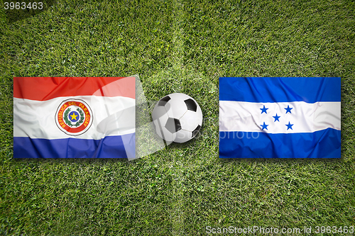 Image of Paraguay vs. Honduras flags on soccer field