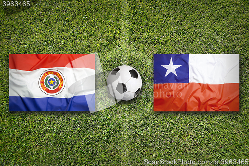 Image of Paraguay vs. Chile flags on soccer field