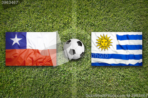 Image of Chile vs. Uruguay flags on soccer field