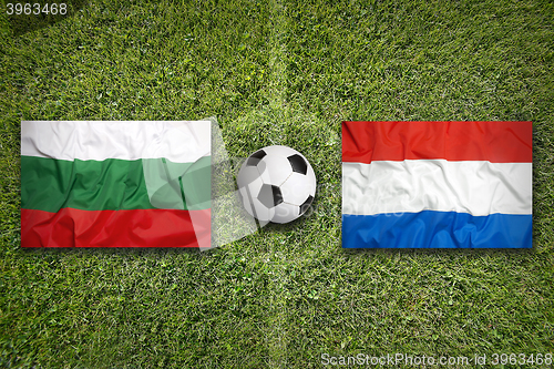 Image of Bulgaria vs. Netherlands flags on soccer field