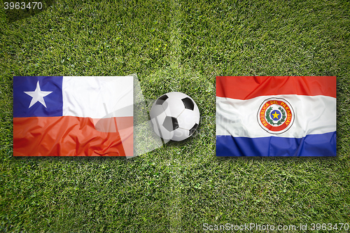 Image of Chile vs. Paraguay flags on soccer field