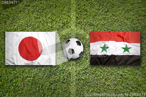 Image of Japan vs. Iraq flags on soccer field