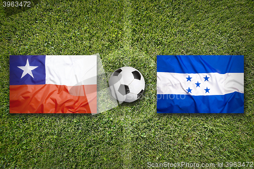 Image of Chile vs. Honduras flags on soccer field