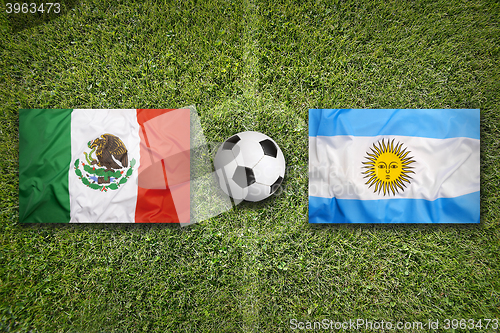 Image of Mexico vs. Argentina flags on soccer field
