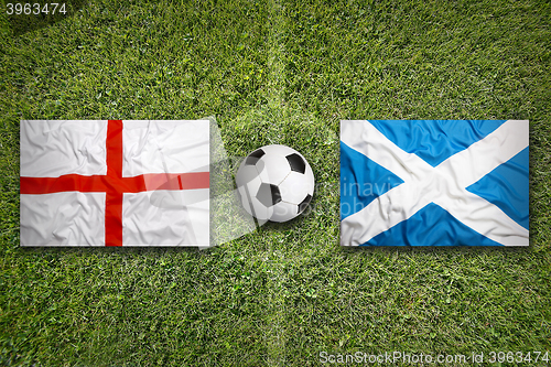 Image of England vs. Scotland flags on soccer field