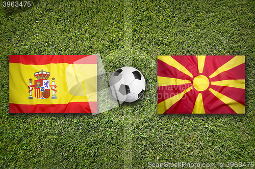 Image of Spain vs. Macedonia flags on soccer field