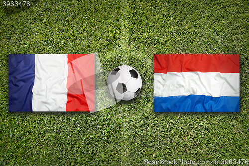 Image of France vs. Netherlands flags on soccer field