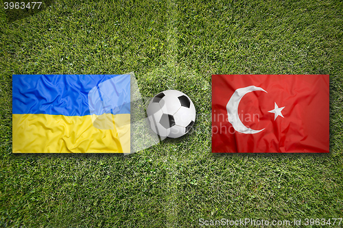 Image of Ukraine vs. Turkey flags on soccer field