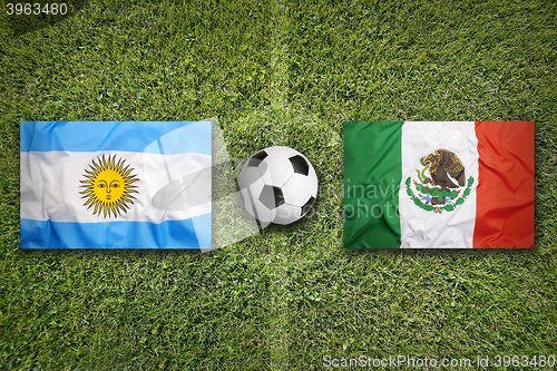 Image of Brazil vs. Mexico flags on soccer field