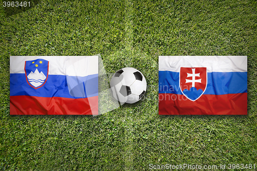 Image of Slovenia vs. Slovakia flags on soccer field