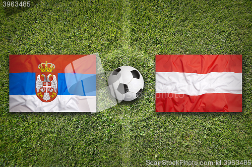 Image of Serbia vs. Austria flags on soccer field